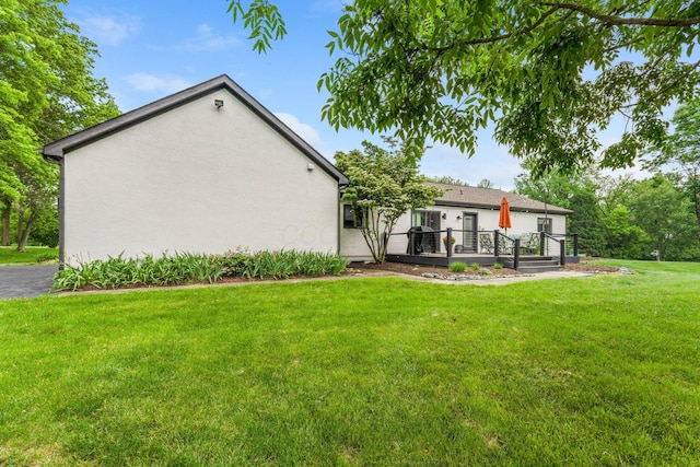 3515 Babbitt Rd, Blacklick, OH 43004 - back of house featuring a deck, a yard, and stucco siding