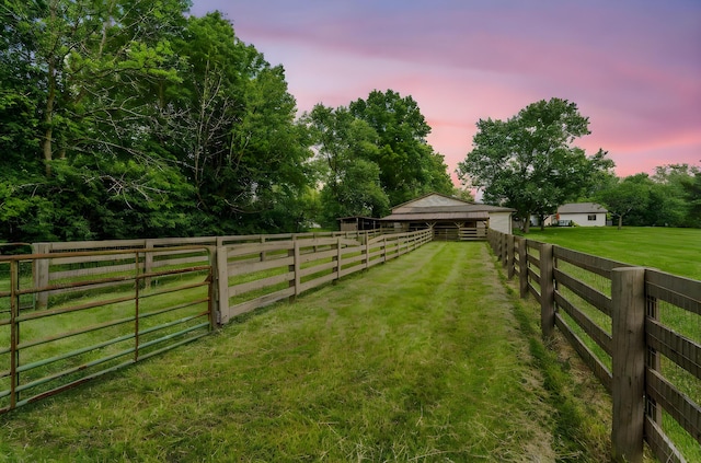 3515 Babbitt Rd, Blacklick, OH 43004 - yard at dusk featuring an outdoor structure, an exterior structure, and a lawn