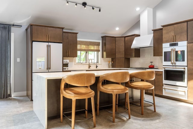 3515 Babbitt Rd, Blacklick, OH 43004 - kitchen featuring white appliances, a warming drawer, a center island, decorative backsplash, and light countertops