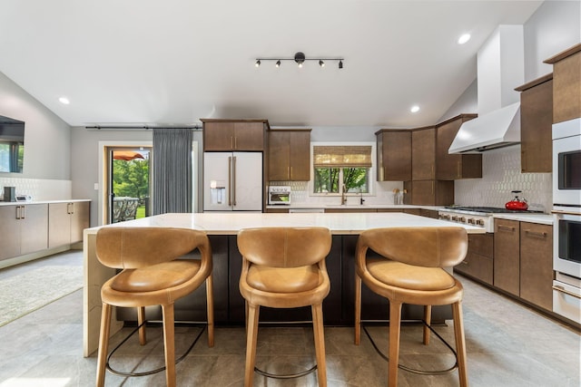 3515 Babbitt Rd, Blacklick, OH 43004 - kitchen with high quality fridge, vaulted ceiling, backsplash, a kitchen island, and light countertops