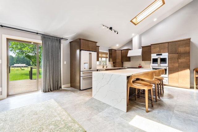 3515 Babbitt Rd, Blacklick, OH 43004 - kitchen featuring white appliances, a kitchen island, track lighting, dark brown cabinets, and high vaulted ceiling