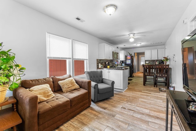 3009 Hiawatha St, Columbus, OH 43224 - living room featuring light wood finished floors and a ceiling fan