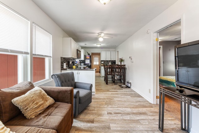 3009 Hiawatha St, Columbus, OH 43224 - living area featuring light wood finished floors, a ceiling fan, and baseboards