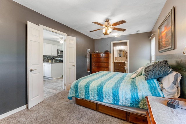 3009 Hiawatha St, Columbus, OH 43224 - bedroom featuring light colored carpet, ceiling fan, connected bathroom, and baseboards