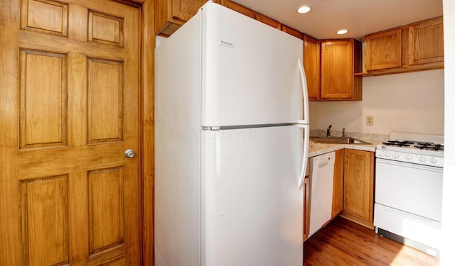 1088 Franklin Ave, Columbus, OH 43205 - kitchen with white appliances, recessed lighting, wood finished floors, and brown cabinets