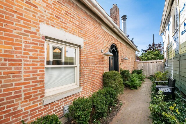 584 Franklin Ave, Columbus, OH 43215 - view of side of home featuring brick siding and a chimney