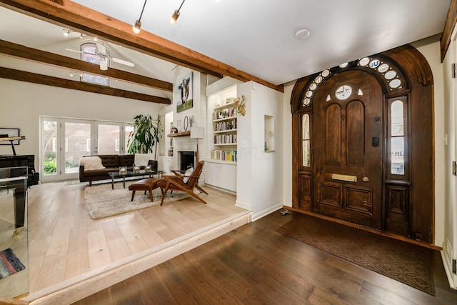 584 Franklin Ave, Columbus, OH 43215 - foyer with beam ceiling, dark wood finished floors, a large fireplace, arched walkways, and baseboards