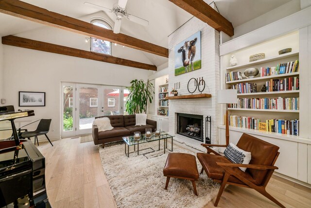 584 Franklin Ave, Columbus, OH 43215 - living area featuring beam ceiling, a ceiling fan, a brick fireplace, wood finished floors, and high vaulted ceiling