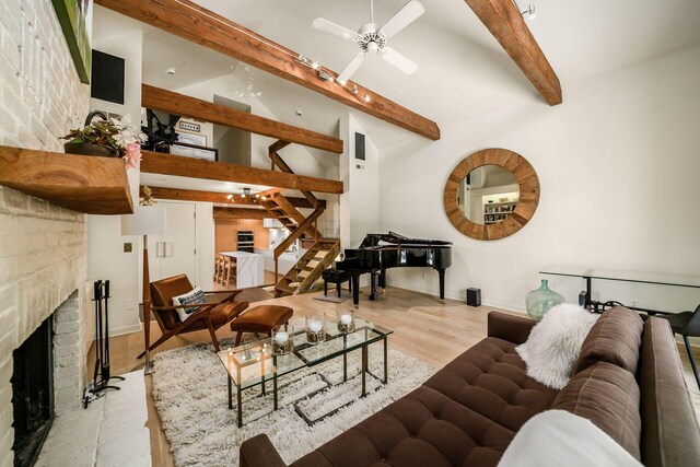 584 Franklin Ave, Columbus, OH 43215 - living room featuring stairs, a fireplace, ceiling fan, wood finished floors, and baseboards