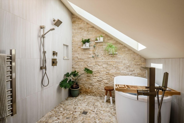 584 Franklin Ave, Columbus, OH 43215 - bathroom featuring a skylight, a towel warming rack, a tile shower, radiator, and lofted ceiling