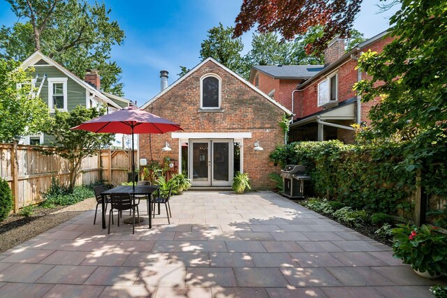 584 Franklin Ave, Columbus, OH 43215 - rear view of property with brick siding, a patio, outdoor dining area, and french doors