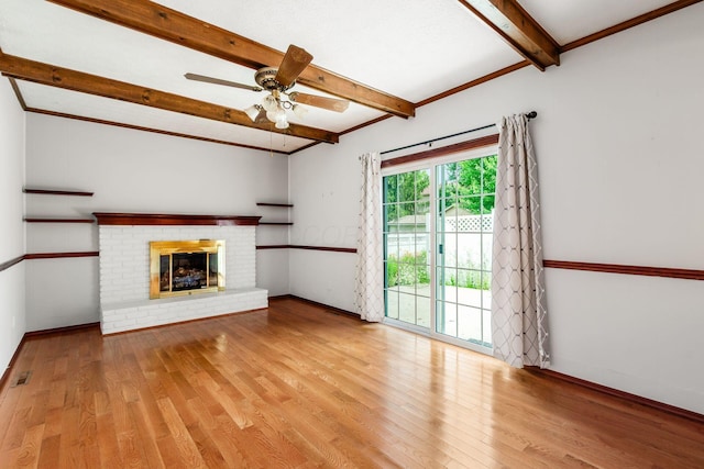 13582 Capetown Ave, Pickerington, OH 43147 - unfurnished living room featuring beamed ceiling, wood finished floors, a ceiling fan, and a brick fireplace