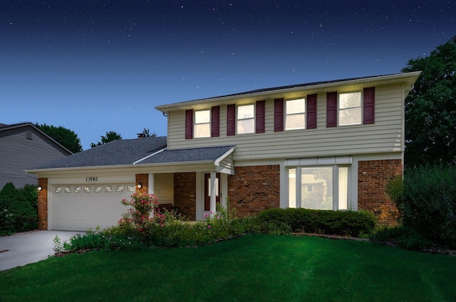 13582 Capetown Ave, Pickerington, OH 43147 - view of front facade with brick siding, a garage, a front lawn, and driveway