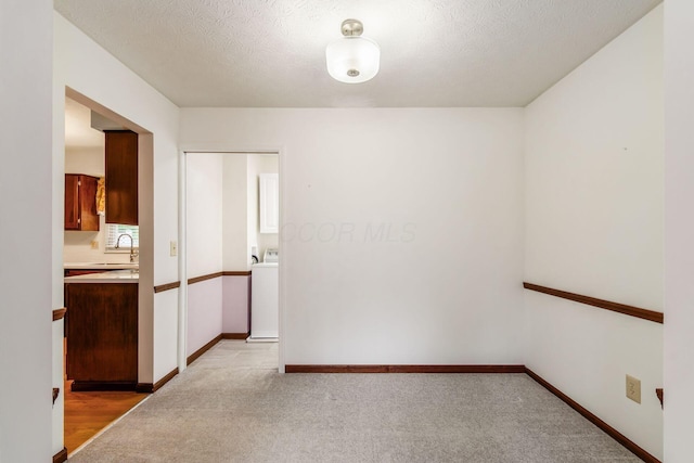 13582 Capetown Ave, Pickerington, OH 43147 - empty room with washer / dryer, a textured ceiling, and light colored carpet