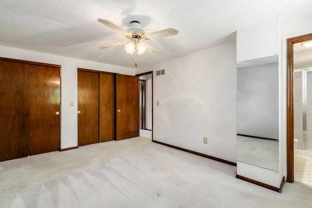 13582 Capetown Ave, Pickerington, OH 43147 - unfurnished bedroom with multiple closets, light carpet, ensuite bathroom, ceiling fan, and a textured ceiling