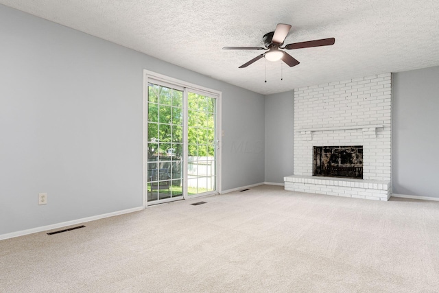 6541 Skywae Dr, Columbus, OH 43229 - unfurnished living room featuring ceiling fan, carpet, a textured ceiling, a brick fireplace, and baseboards