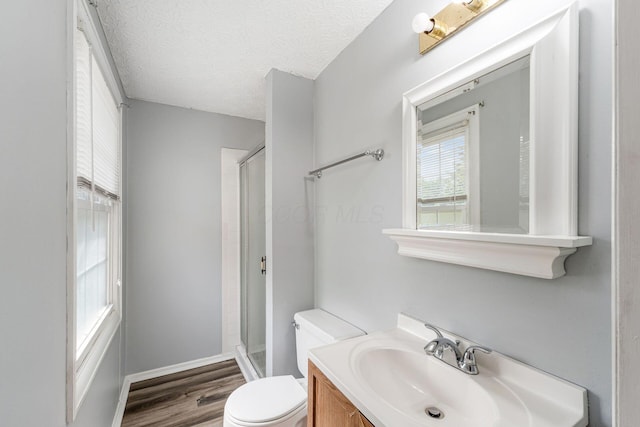 6541 Skywae Dr, Columbus, OH 43229 - full bath featuring toilet, vanity, a stall shower, wood finished floors, and a textured ceiling