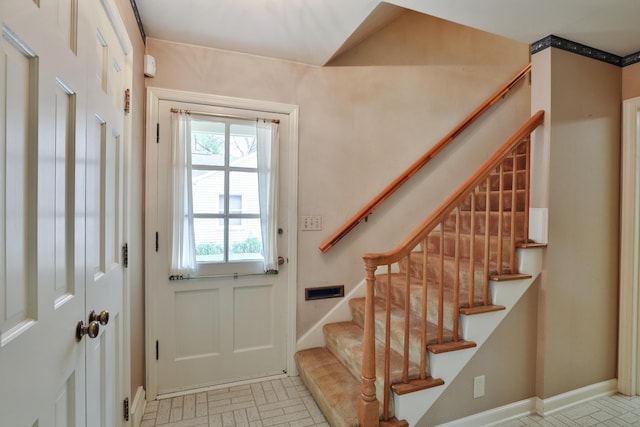 4399 Colerain Ave, Columbus, OH 43214 - entrance foyer featuring stairs, brick patterned floors, and baseboards