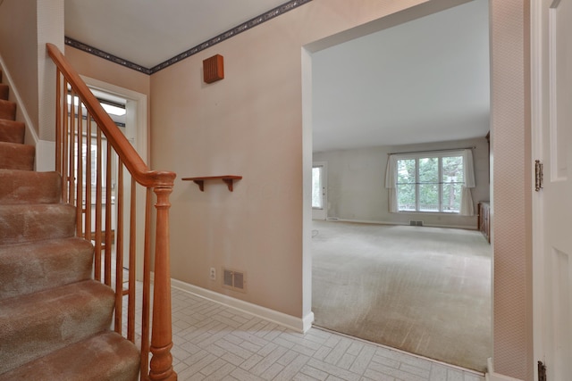 4399 Colerain Ave, Columbus, OH 43214 - stairway with baseboards, brick patterned floors, and radiator heating unit