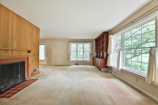 4399 Colerain Ave, Columbus, OH 43214 - unfurnished living room featuring baseboards, carpet, and a brick fireplace