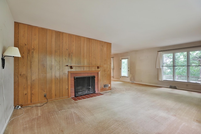 4399 Colerain Ave, Columbus, OH 43214 - unfurnished living room with wooden walls, a fireplace, carpet floors, and baseboards