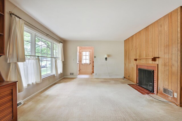 4399 Colerain Ave, Columbus, OH 43214 - unfurnished living room with light carpet, baseboards, a brick fireplace, and wood walls