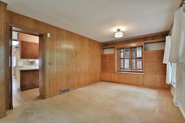 4399 Colerain Ave, Columbus, OH 43214 - carpeted empty room featuring wood walls and baseboards