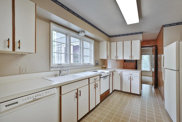 4399 Colerain Ave, Columbus, OH 43214 - kitchen with white appliances, a sink, light countertops, and white cabinets