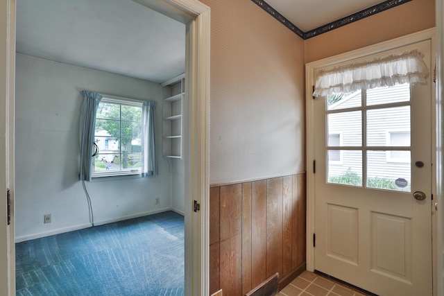 4399 Colerain Ave, Columbus, OH 43214 - doorway with baseboards, wainscoting, and carpet flooring