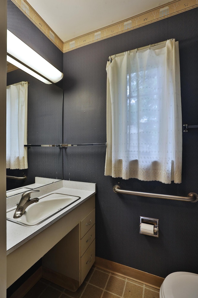 4399 Colerain Ave, Columbus, OH 43214 - bathroom featuring vanity, toilet, and tile patterned flooring