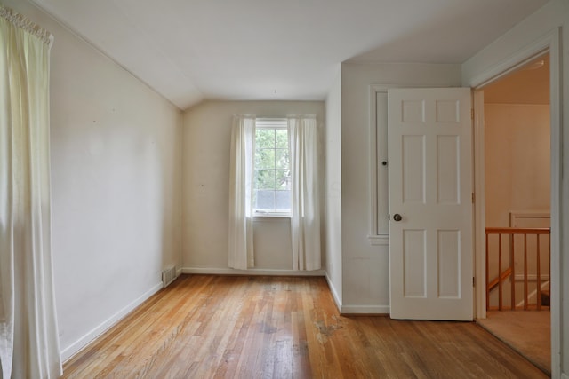 4399 Colerain Ave, Columbus, OH 43214 - unfurnished bedroom with hardwood / wood-style flooring, baseboards, and lofted ceiling