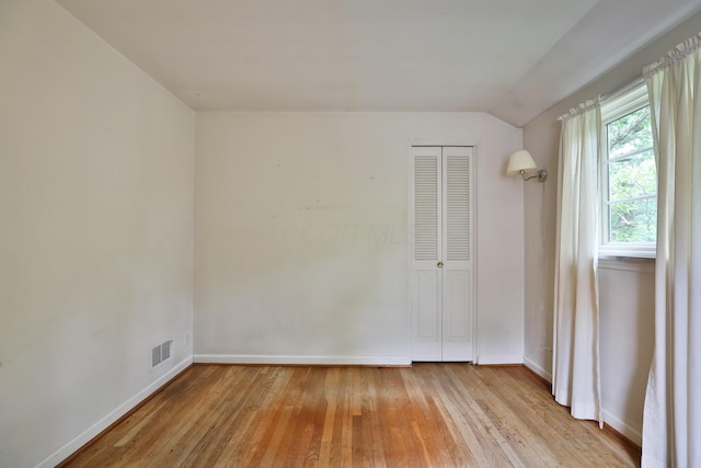4399 Colerain Ave, Columbus, OH 43214 - spare room with light wood-style flooring, baseboards, and lofted ceiling