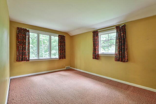 4399 Colerain Ave, Columbus, OH 43214 - carpeted empty room with plenty of natural light, vaulted ceiling, and baseboards
