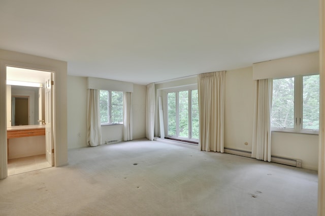 4399 Colerain Ave, Columbus, OH 43214 - spare room with carpet and a baseboard heating unit