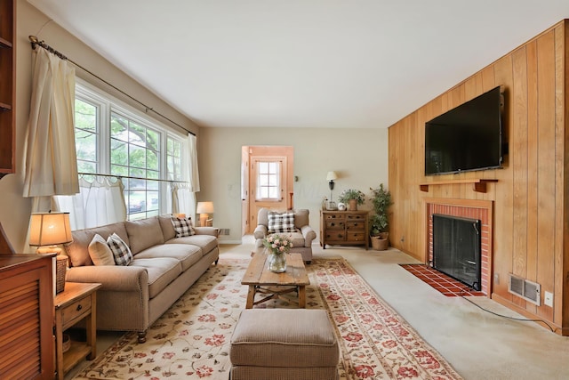 4399 Colerain Ave, Columbus, OH 43214 - living room featuring wood walls and a fireplace