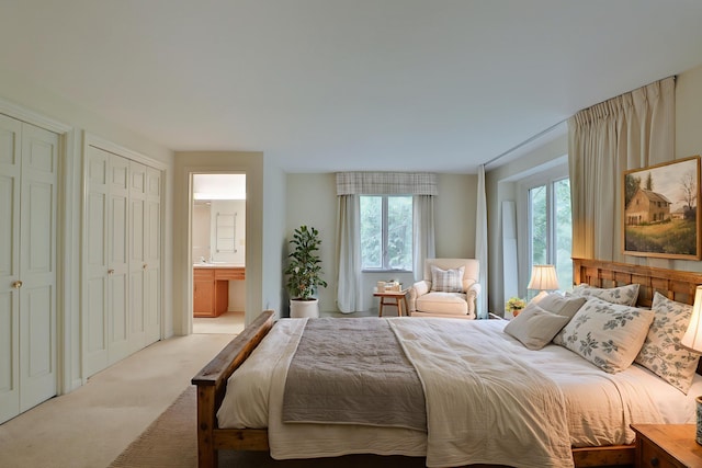 4399 Colerain Ave, Columbus, OH 43214 - bedroom with light colored carpet, multiple closets, and ensuite bathroom