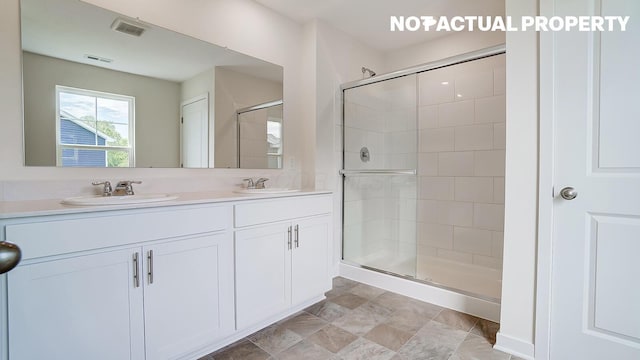 1486 Chrisman Dr, Columbus, OH 43223 - bathroom with a shower stall, double vanity, and stone finish flooring