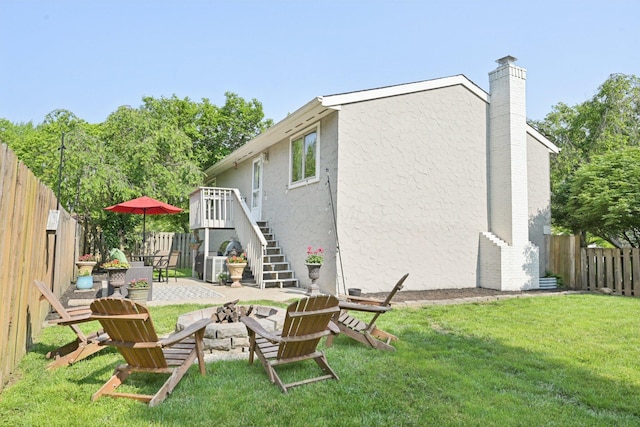 4561 Valley Quail Blvd N, Westerville, OH 43081 - rear view of house featuring a fire pit, stucco siding, stairway, a patio area, and a chimney