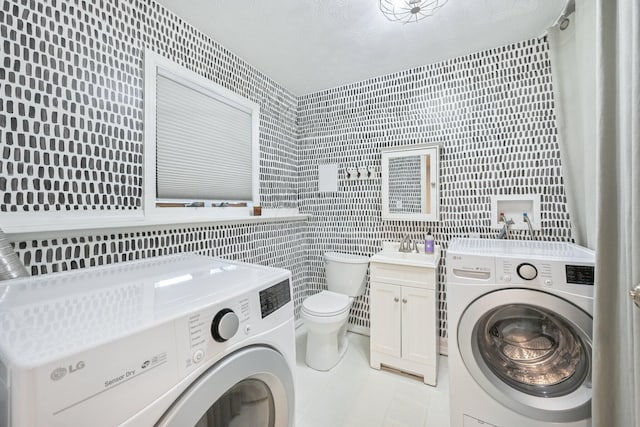 4561 Valley Quail Blvd N, Westerville, OH 43081 - laundry area with washer and clothes dryer, tile walls, light tile patterned floors, and a textured ceiling