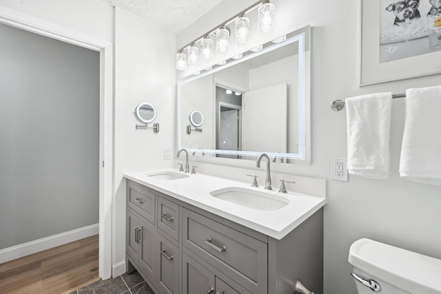 4561 Valley Quail Blvd N, Westerville, OH 43081 - full bathroom featuring double vanity, toilet, a textured ceiling, and baseboards