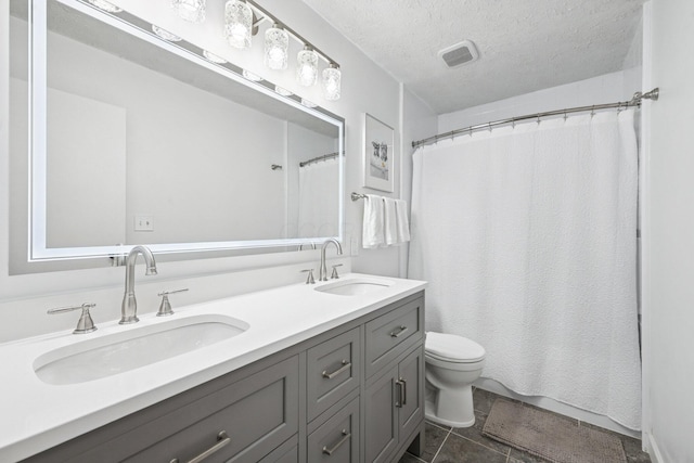 4561 Valley Quail Blvd N, Westerville, OH 43081 - full bathroom with double vanity, toilet, a textured ceiling, tile patterned flooring, and curtained shower
