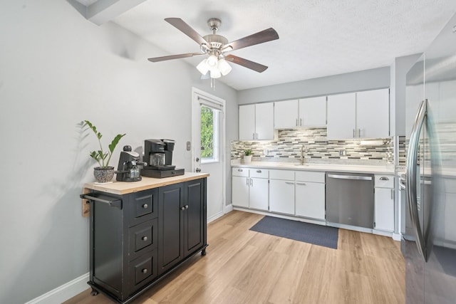 4561 Valley Quail Blvd N, Westerville, OH 43081 - kitchen with stainless steel appliances, light countertops, white cabinetry, backsplash, and ceiling fan