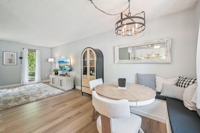 4561 Valley Quail Blvd N, Westerville, OH 43081 - dining room featuring a chandelier, wood finished floors, and baseboards