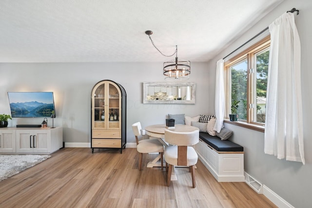 4561 Valley Quail Blvd N, Westerville, OH 43081 - dining space with light wood finished floors, a chandelier, and baseboards