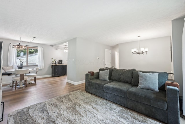 4561 Valley Quail Blvd N, Westerville, OH 43081 - living room featuring a chandelier, wood finished floors, a ceiling fan, and baseboards