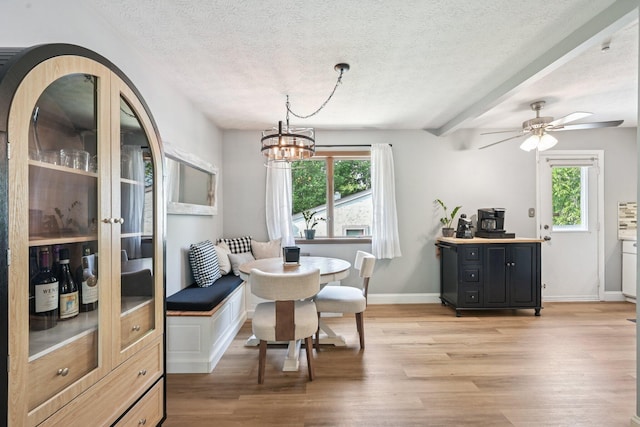 4561 Valley Quail Blvd N, Westerville, OH 43081 - dining room featuring light wood-style floors, healthy amount of natural light, a textured ceiling, and baseboards