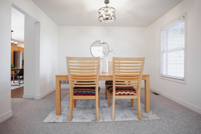 1808 Primrose Ave, Lewis Center, OH 43035 - dining area featuring light colored carpet, baseboards, and a chandelier