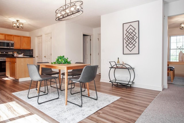 1808 Primrose Ave, Lewis Center, OH 43035 - dining area with light wood-style flooring, baseboards, and a chandelier