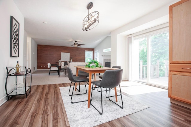 1808 Primrose Ave, Lewis Center, OH 43035 - dining area featuring an accent wall, wood finished floors, a ceiling fan, baseboards, and wood walls