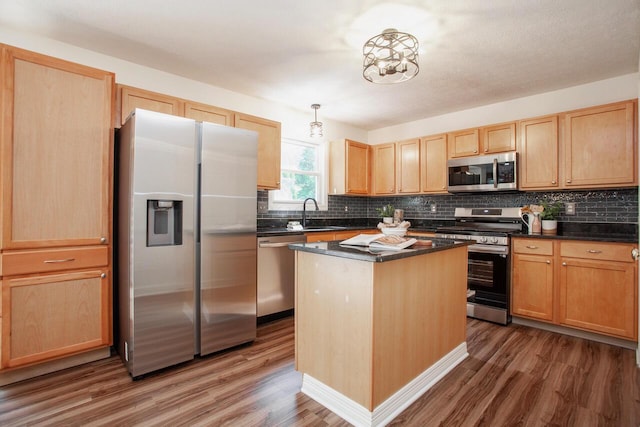 1808 Primrose Ave, Lewis Center, OH 43035 - kitchen with appliances with stainless steel finishes, light brown cabinets, wood finished floors, dark countertops, and tasteful backsplash